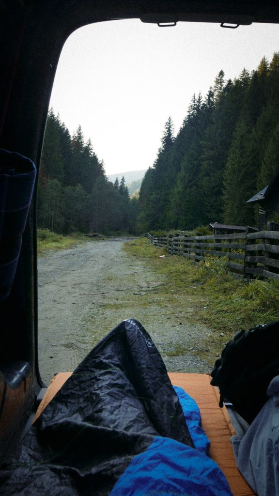 Early morning view from a van toward a forest road in the Carpathian Mountains before a trail running ultramarathon.